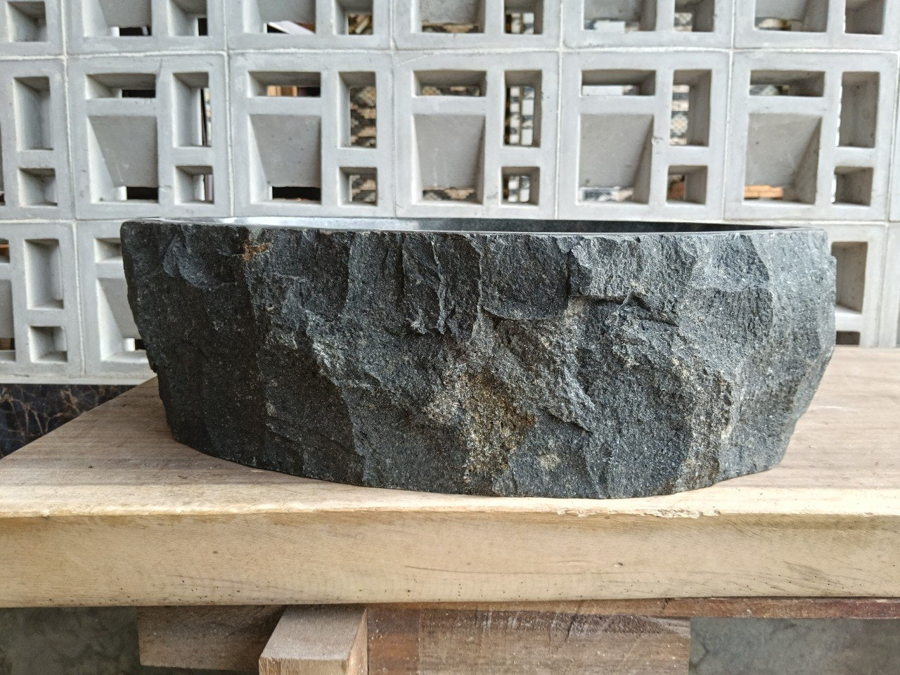 Back view of A42-5041 natural andesite basin — textured exterior surface
