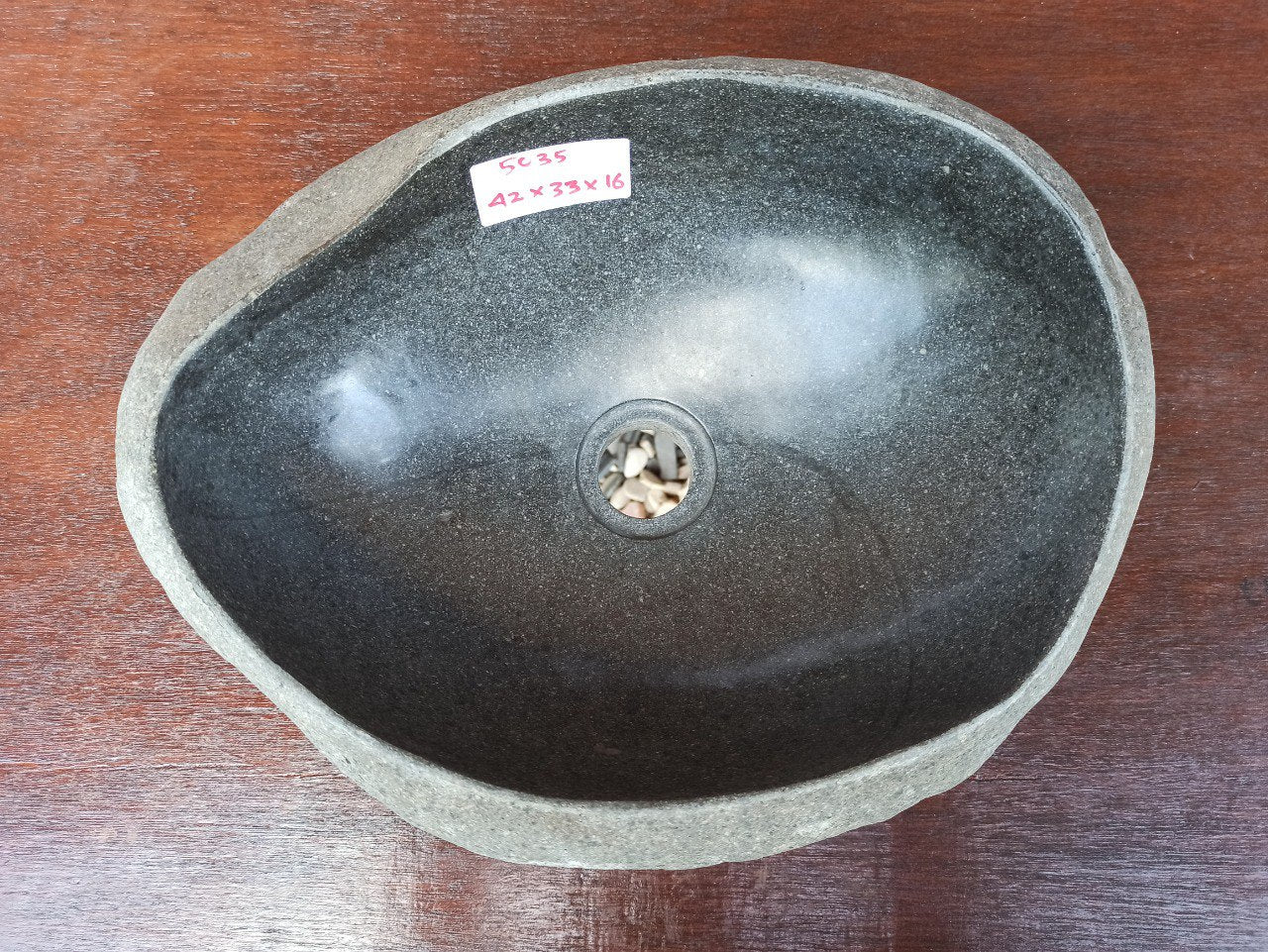 Top view of 5035-423316 natural river stone sink — polished interior and textured exterior
