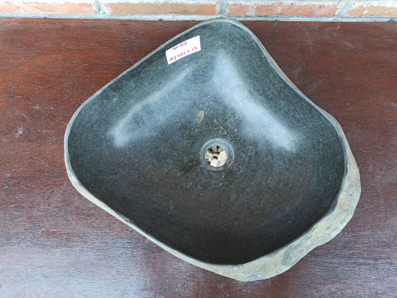 Top view of 5053-494117 natural river stone sink — polished interior and rough exterior surface
