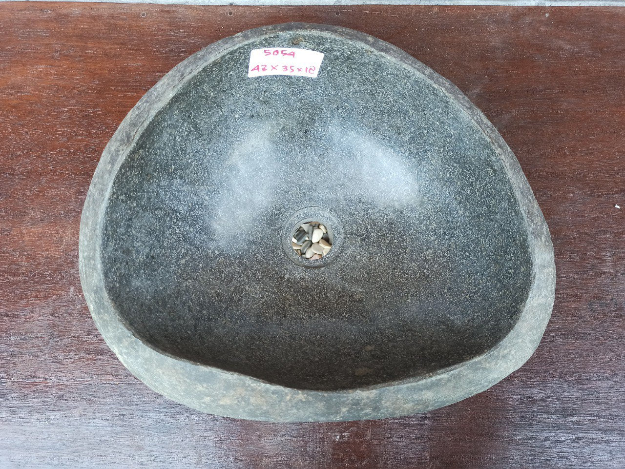 Top view of 5054-433518 natural river stone sink — polished interior and rough stone exterior
