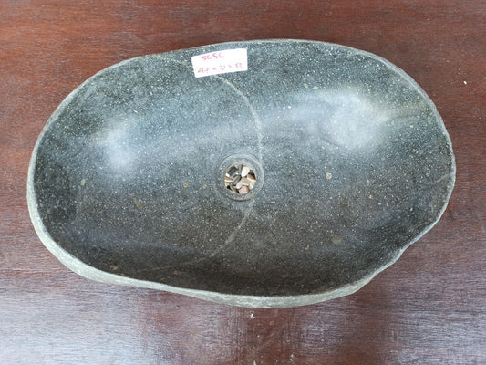 Top view of 5056-473113 handcrafted river stone sink — polished interior, rough exterior texture
