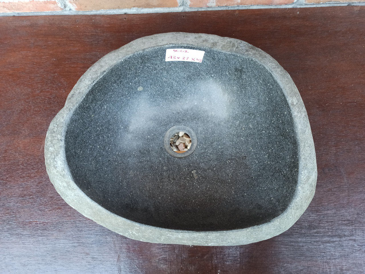 Top view of 5062-433719 river stone sink — deep handcrafted basin with polished interior and rough edge
