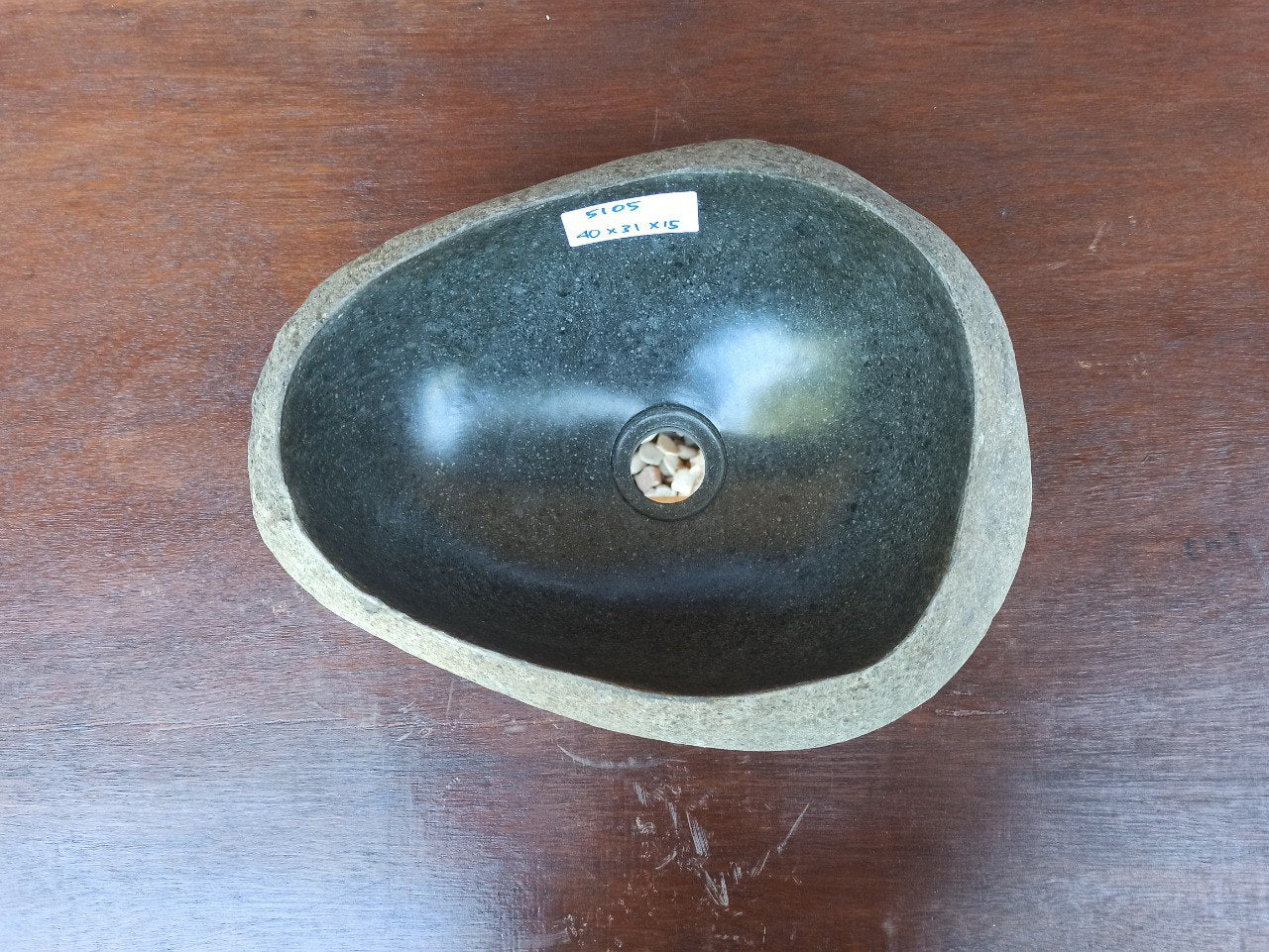 Top view of 5105-4031 handcrafted river stone sink — smooth dark basin, rough natural exterior
