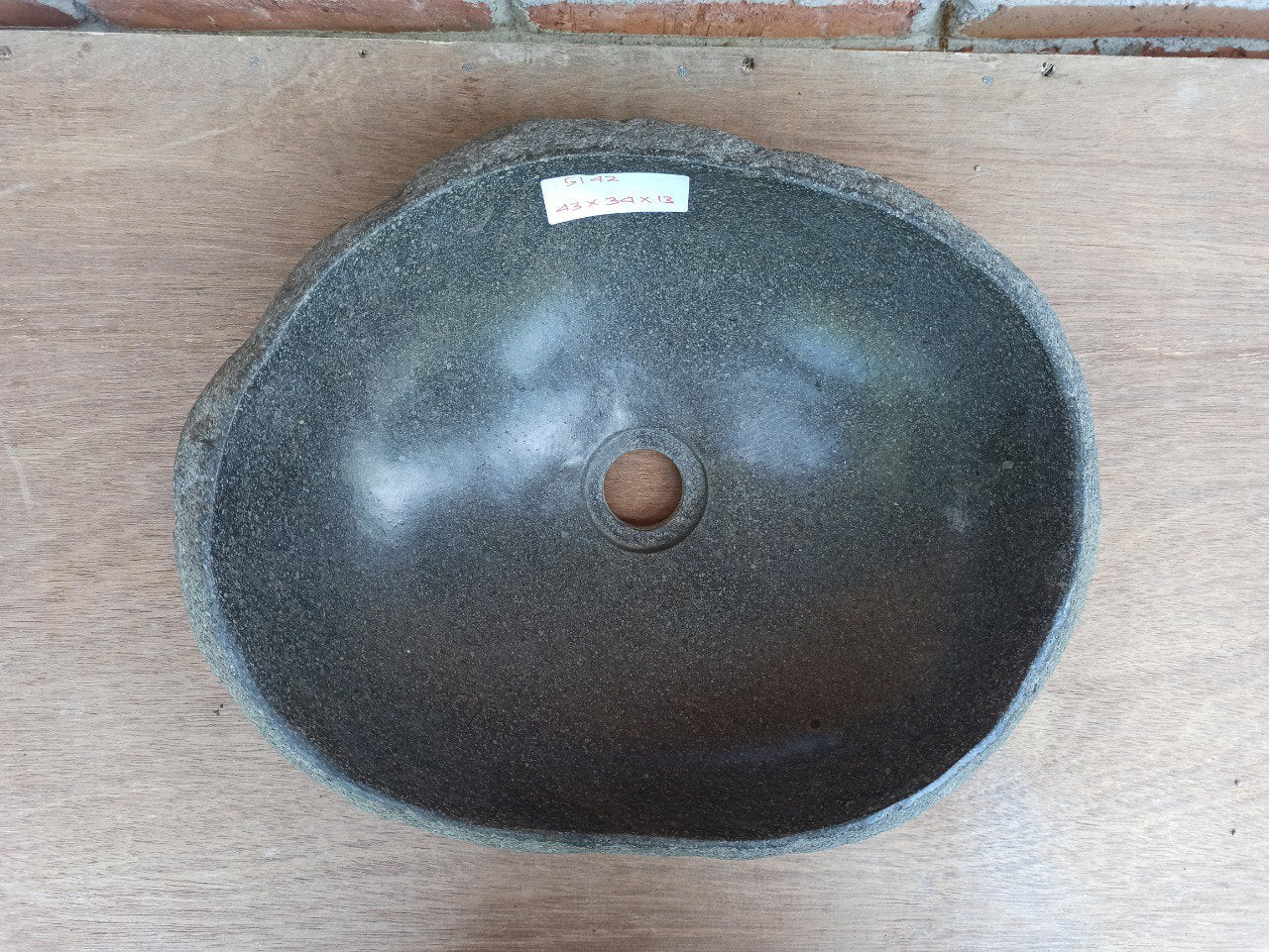 Top view of 5142-433413 oval river stone sink — handcrafted with polished dark gray interior
