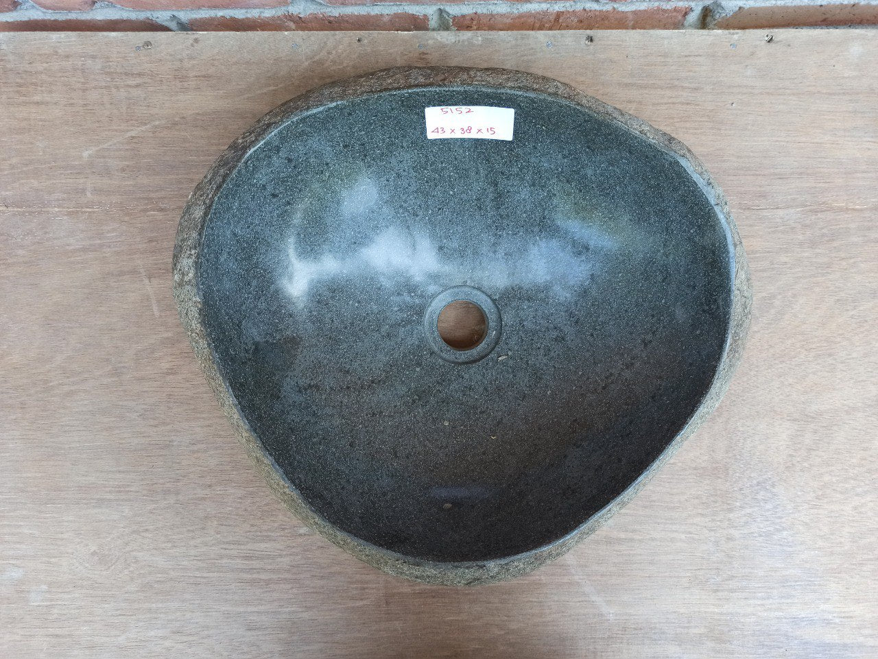 Top view of 5152-4338 triangular river stone sink — polished interior and rough stone exterior
