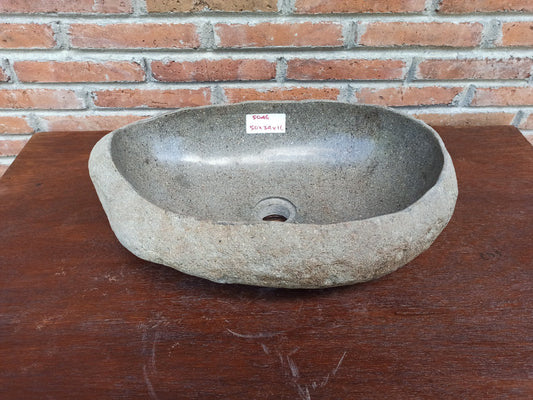 Top view of 5046-503416 oval river stone sink — polished dark interior and textured stone exterior
