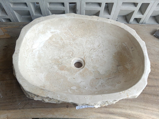 Top view of A5-5643 cream-beige marble sink with polished interior and rough natural exterior, elongated organic oval shape.
