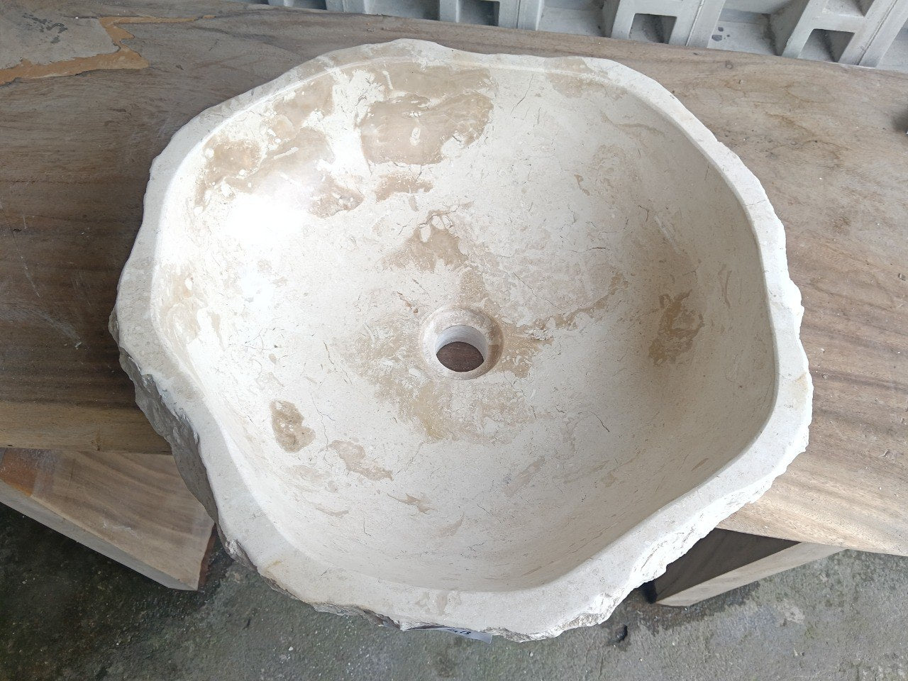 Top view of A6-4948 cream–ivory marble sink with polished interior and rough natural exterior, organic round-oval shape.
