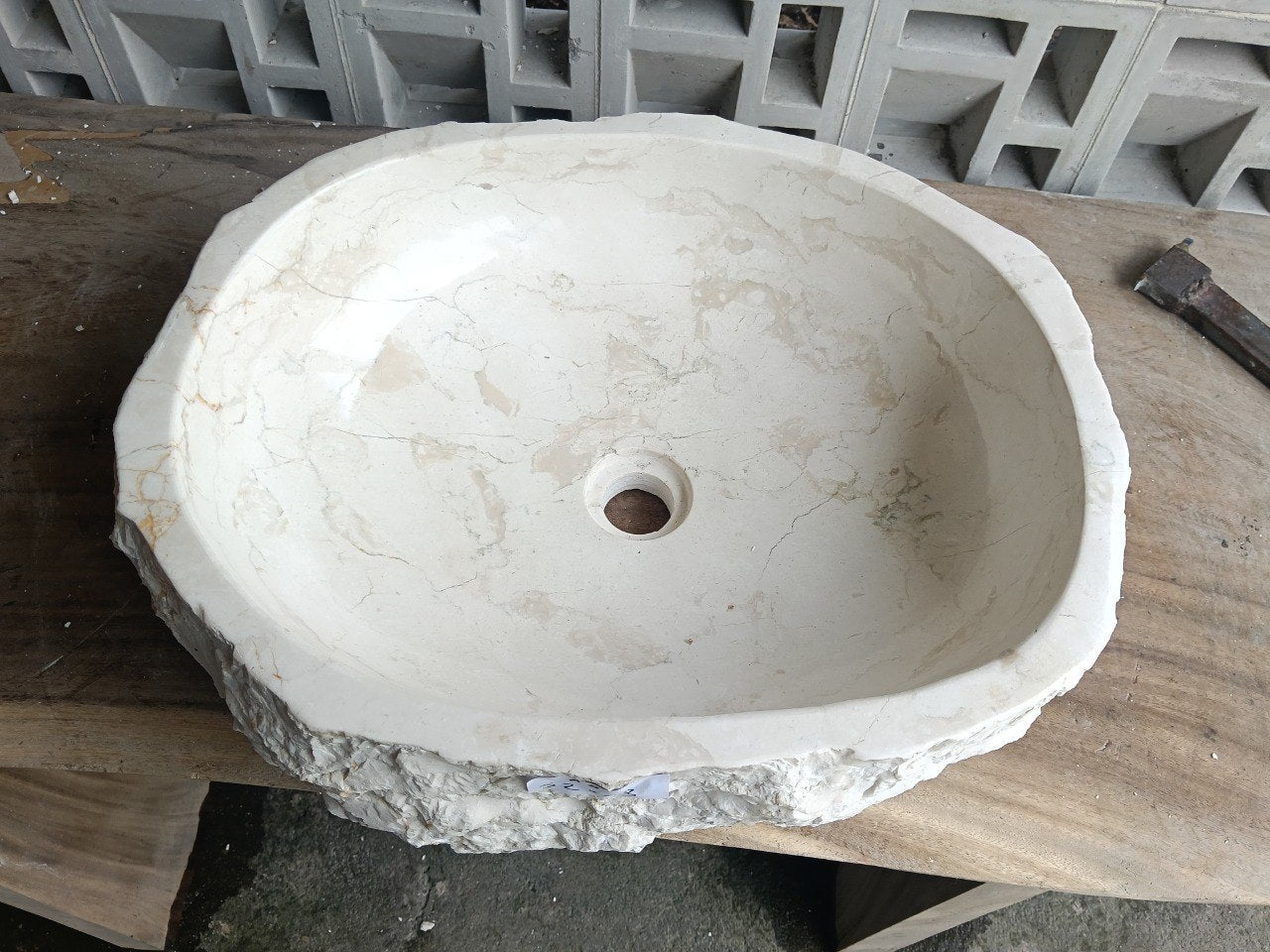 Top view of A8-5243 white–cream marble sink with polished interior and rough natural exterior, organic round-oval shape.
