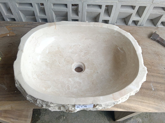 Top view of A9-5644 cream–beige marble sink with polished interior and rough natural exterior, organic oval-rectangular shape.
