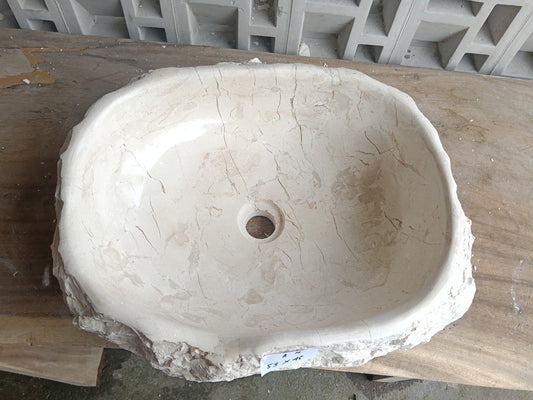 Top view of A14-5345 cream-white marble sink with polished interior and rough natural exterior, organic round-oval shape.
