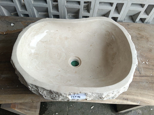 Top view of A20-5742 cream-white marble sink with polished interior and rough natural exterior, elongated organic oval shape.
