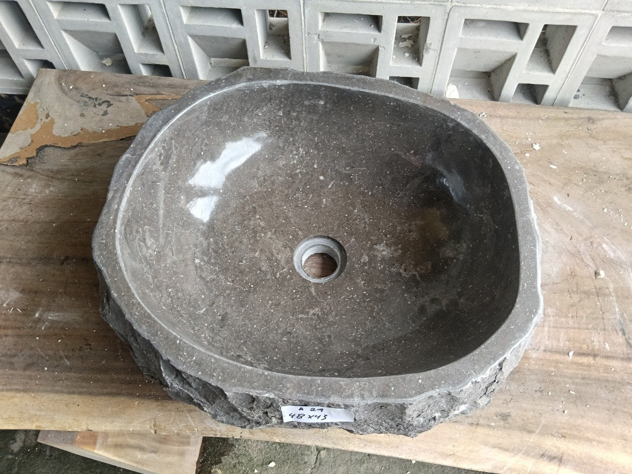 Top view of A24-4843 brown–taupe marble sink with polished interior and rough natural exterior, organic oval-rectangular shape.
