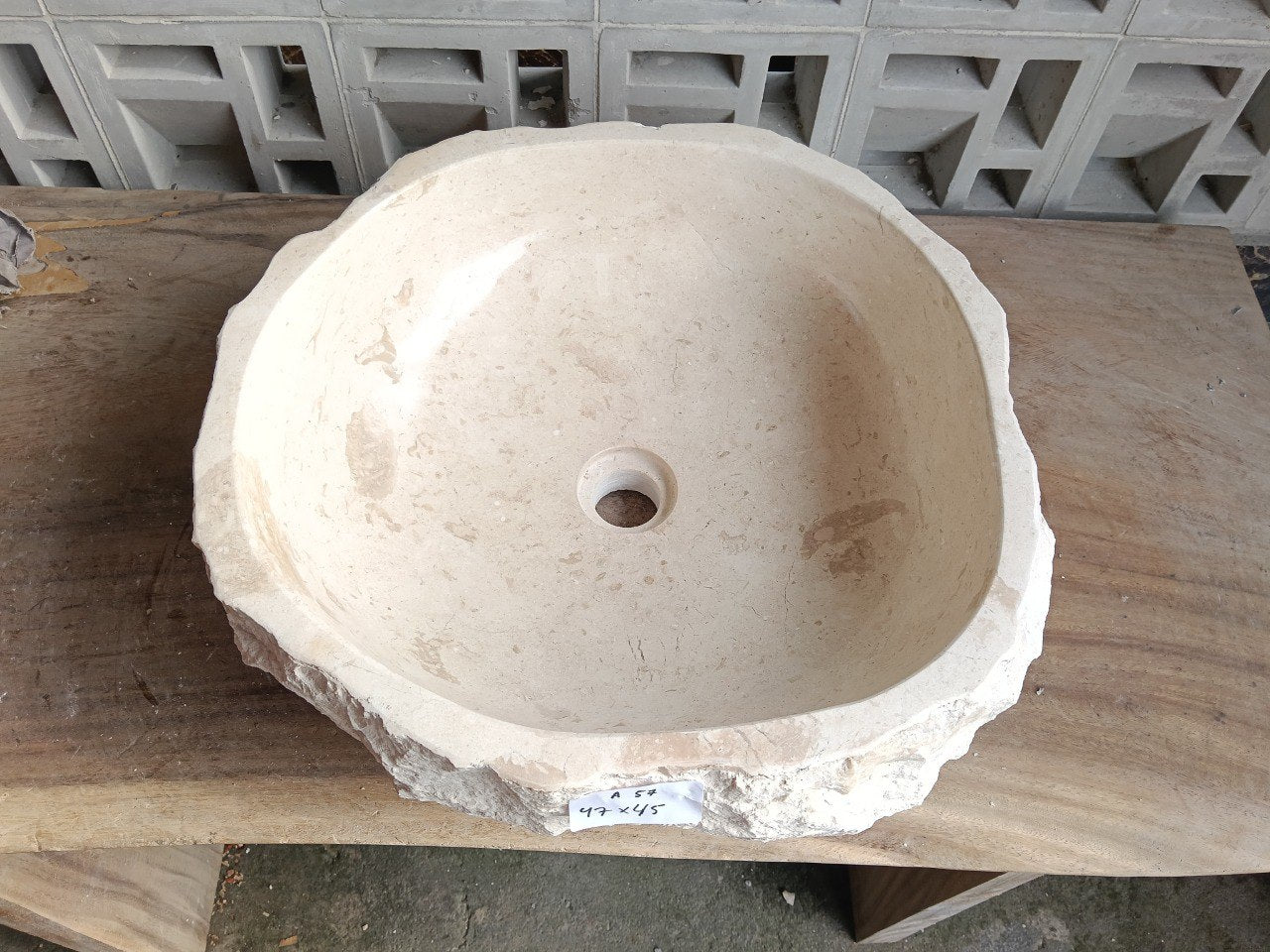 Top view of A57-4745 cream–ivory marble sink with polished interior and rough natural exterior, organic round-oval shape.
