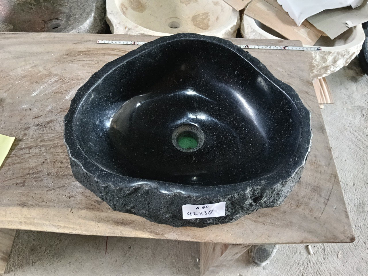 Top view of A90-4336 black andesite stone sink with polished interior and rough chiseled exterior, organic round-oval shape.

