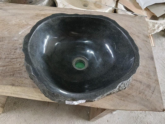 Top view of A98-4336 black andesite stone sink with polished interior and rough chiseled exterior, organic round-oval shape.
