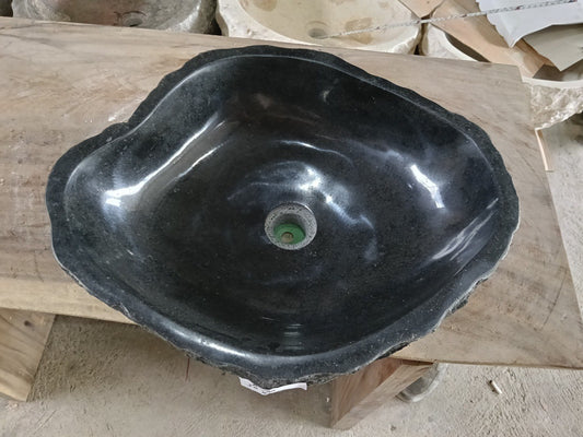 Top view of A100-5042 black andesite stone sink with polished interior and rough chiseled exterior, organic irregular shape.
