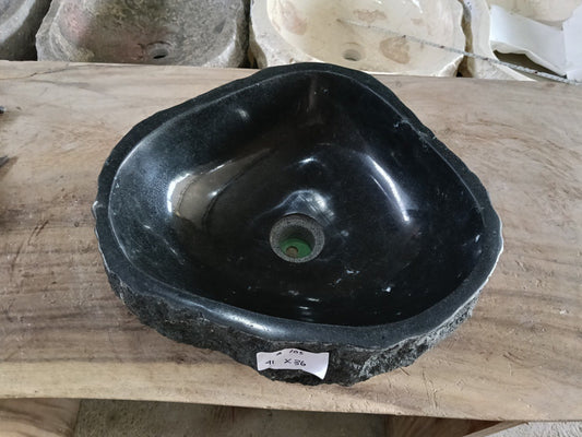 Top view of A105-4136 black andesite stone sink with polished interior and rough chiseled exterior, organic triangular-oval shape.
