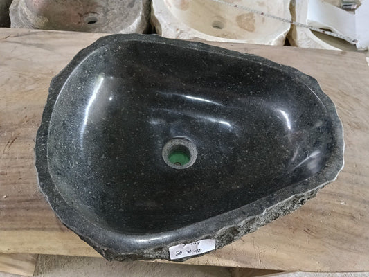 Top view of A107-5040 black andesite stone sink with polished interior and rough chiseled exterior, triangular organic shape.
