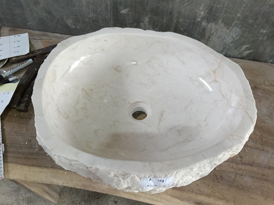 Top view of A109-5647 white marble sink with polished interior and rough natural exterior, organic oval shape.
