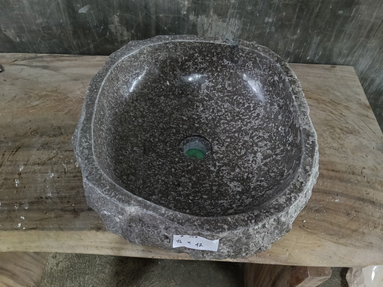 Top view of A123-4642 polished dark marble sink with speckled texture, organic round-oval shape.
