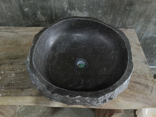 Top view of A131-4545 black andesite stone sink with polished interior and rough chiseled exterior, round shape.
