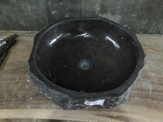 Top view of A136-4545 black andesite stone sink with polished interior and rough chiseled exterior, round shape.
