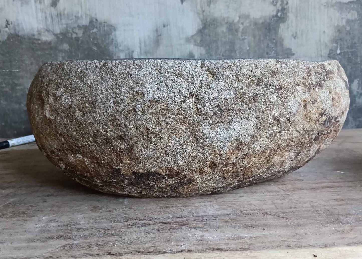 Back view of handcrafted sink 6528 with rustic stone shell and smooth edges

