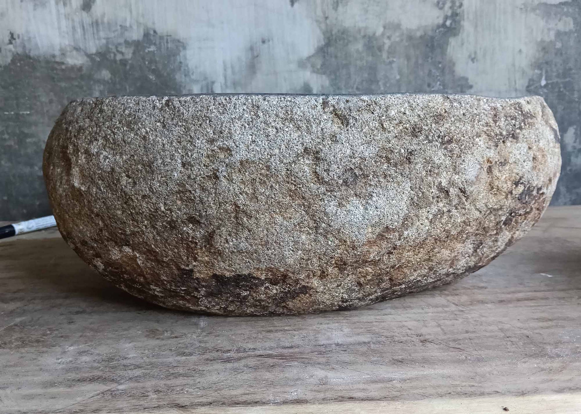 Back view of handcrafted sink 6528 with rustic stone shell and smooth edges
