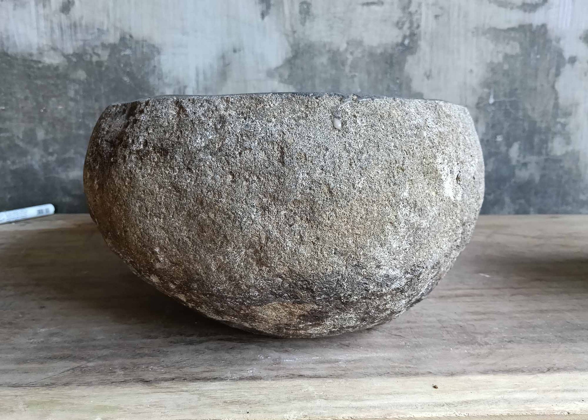 Left side angle of sink 6528 showing asymmetrical organic form and raw exterior
