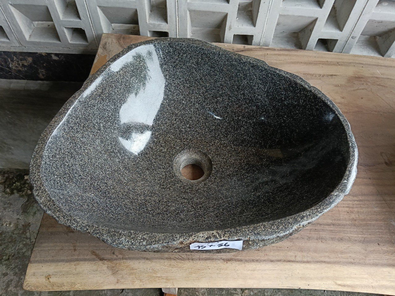 Top view of 6705-4336 triangular river stone sink with polished gray interior

