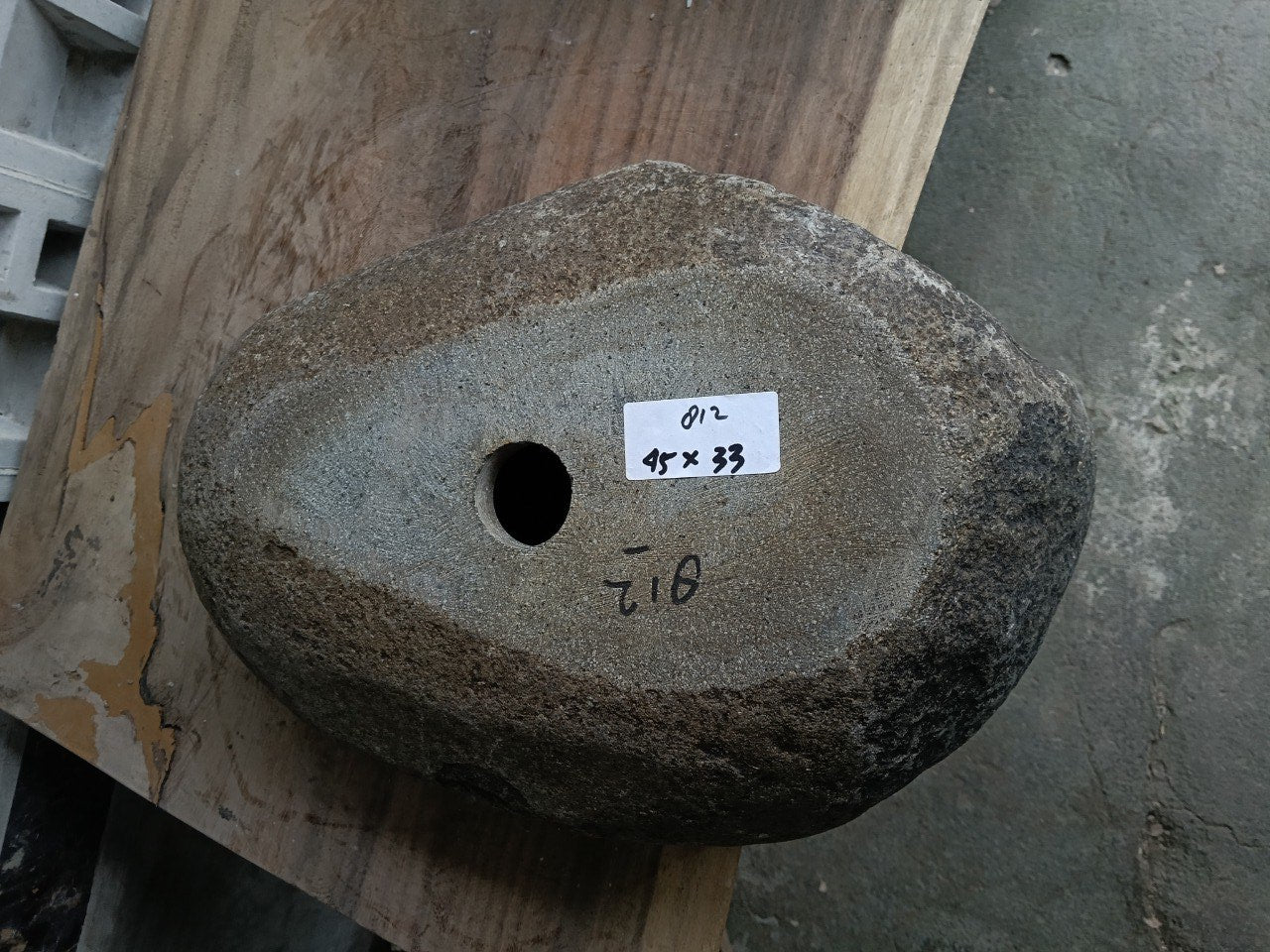 Bottom view of 6812-4533 solid river stone sink — standard drain hole
