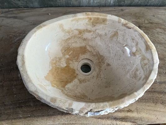 Top view of A181-4434 cream–beige marble sink with polished interior and rough natural exterior, organic oval shape.

