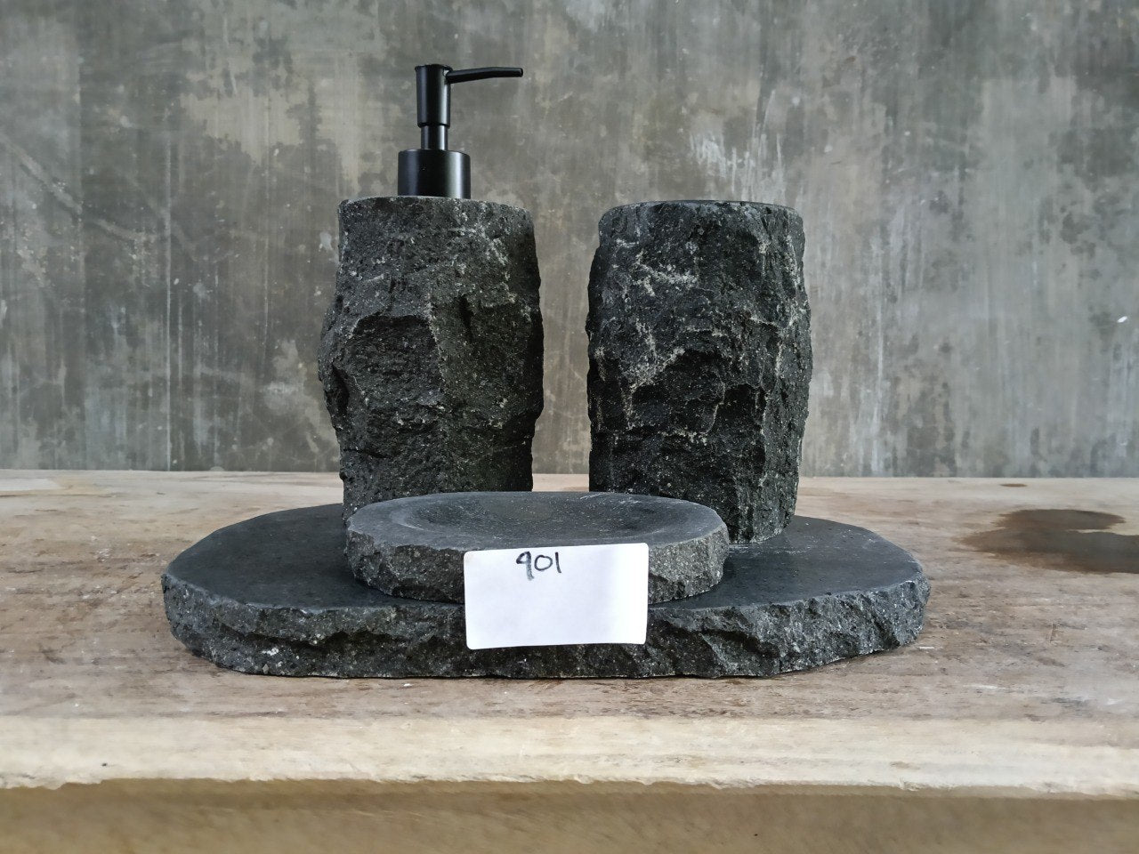 Hand-carved andesite stone bathroom set with dispenser, toothbrush holder, soap dish, and stone tray.
