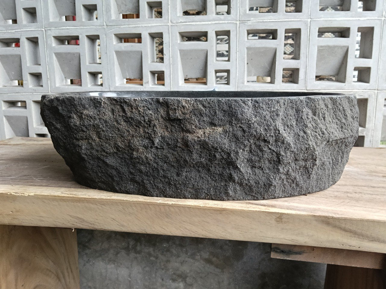 Left side perspective of oval andesite basin polished interior
