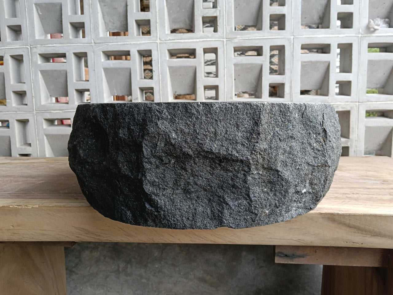 Left side perspective of oval andesite basin polished interior
