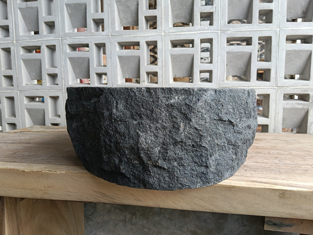 Right side perspective of handcrafted dark gray stone sink
