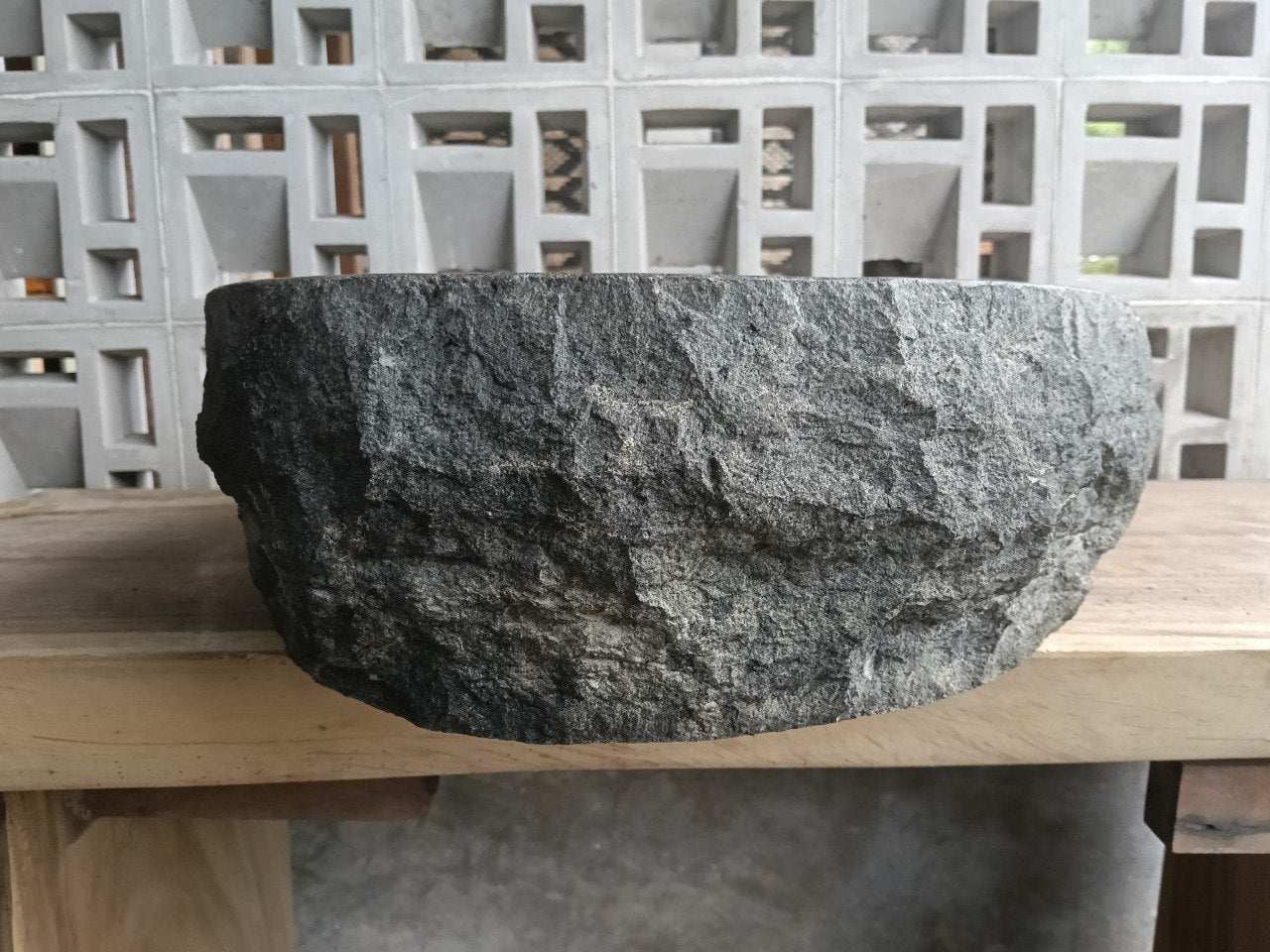 Left side perspective of oval andesite basin polished interior
