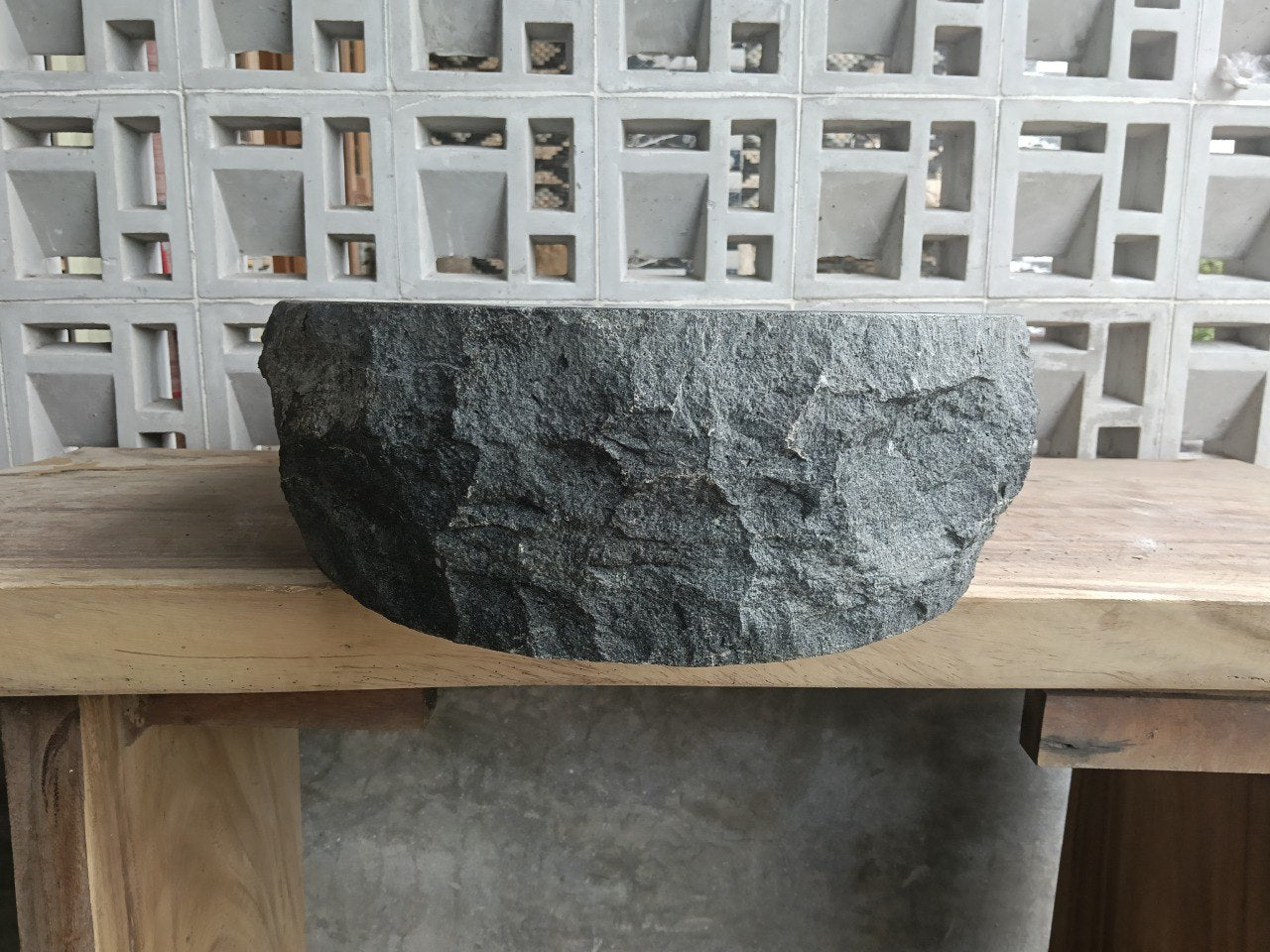 Right side perspective of handcrafted dark gray stone sink
