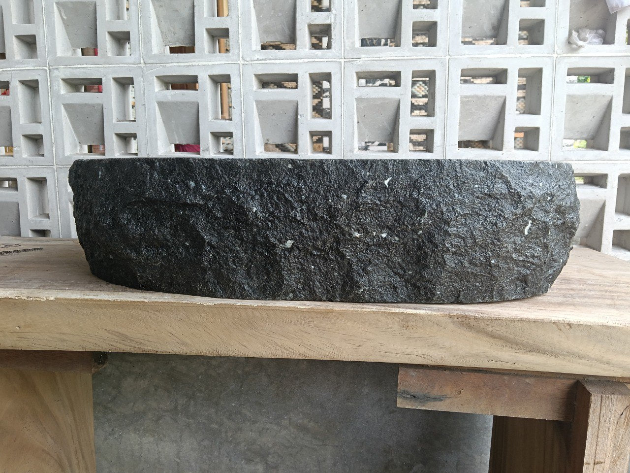 Left side perspective of oval andesite basin polished interior

