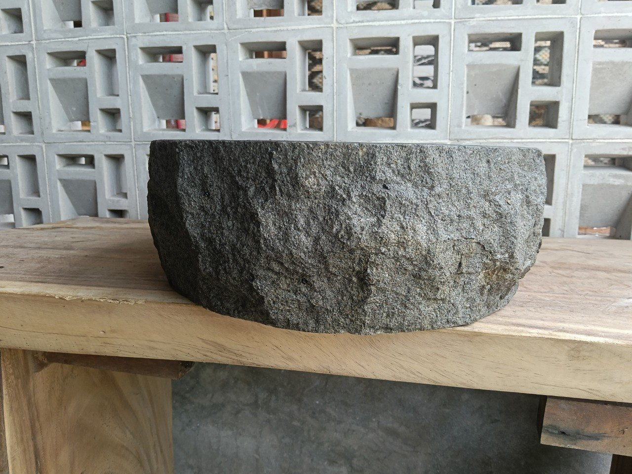 Left side perspective of oval andesite basin polished interior
