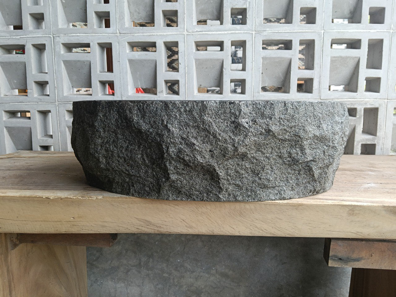 Right side perspective of handcrafted light gray stone sink
