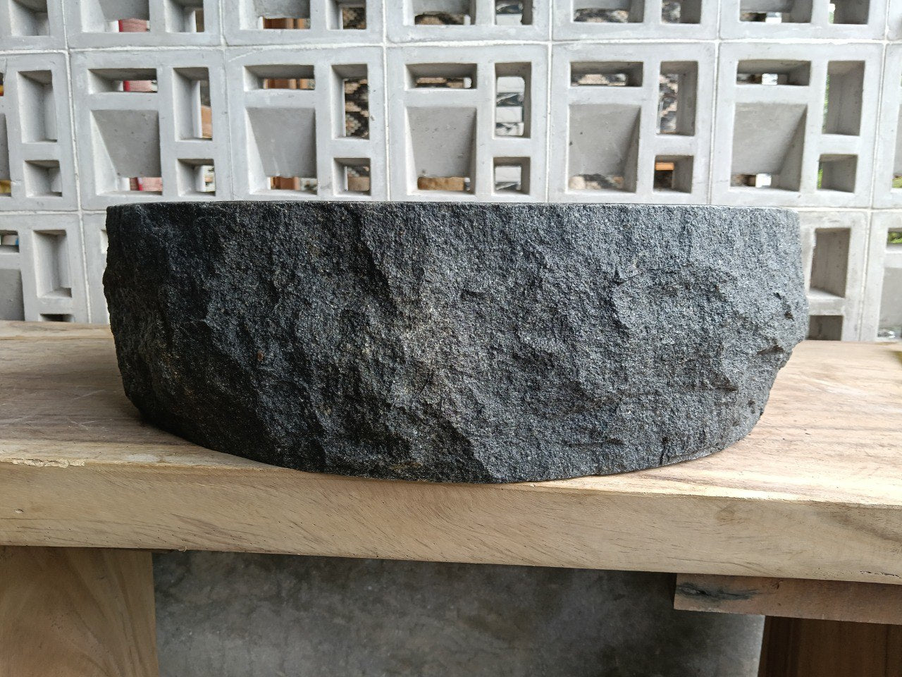 Left side perspective of oval andesite basin polished interior
