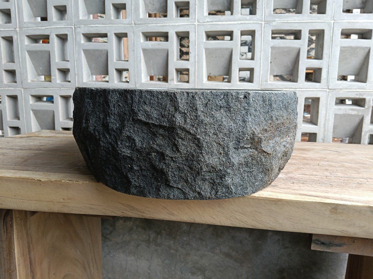 Right side perspective of handcrafted dark gray stone sink
