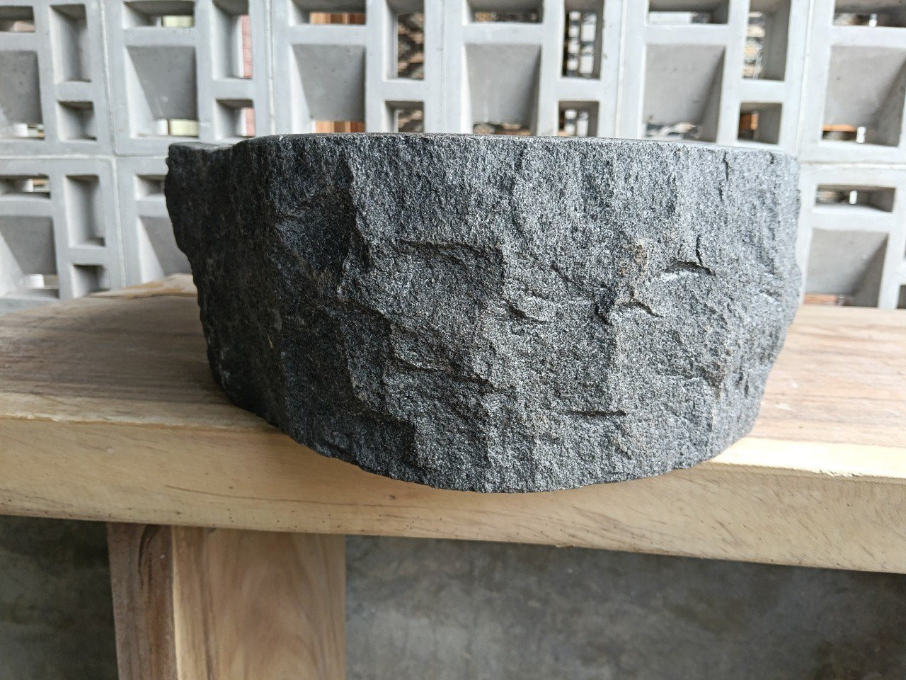 Left side perspective of polished oval andesite stone basin
