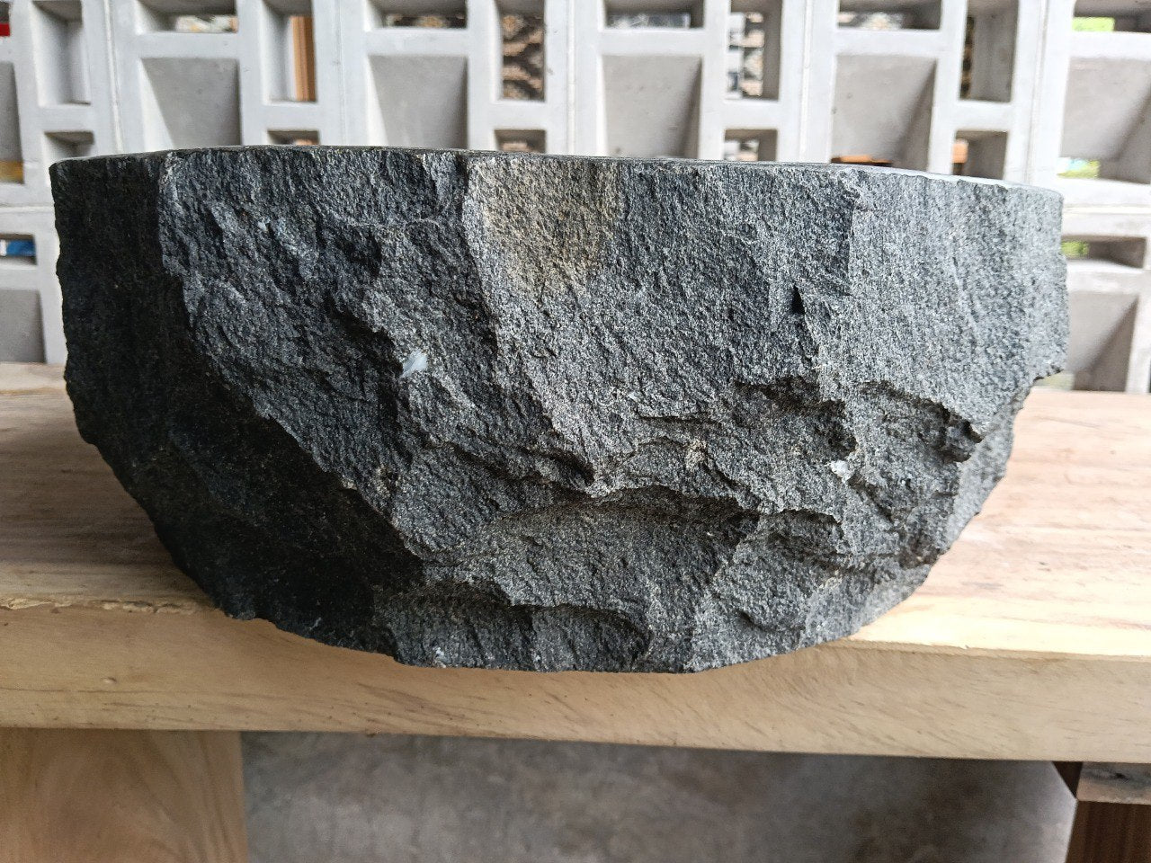 Left side perspective of oval andesite basin polished interior
