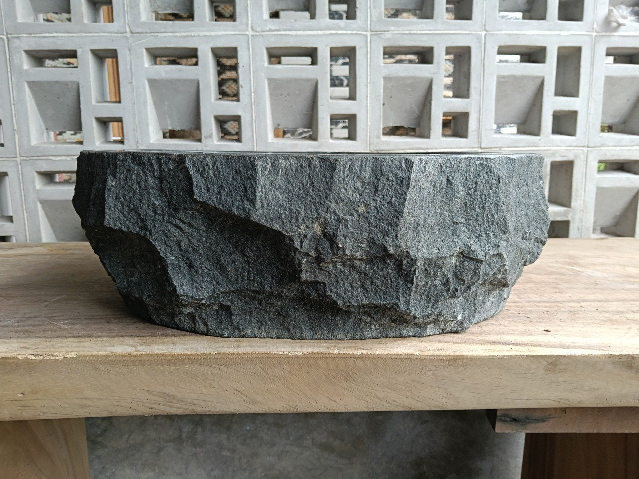 Right side perspective of handcrafted dark gray stone sink
