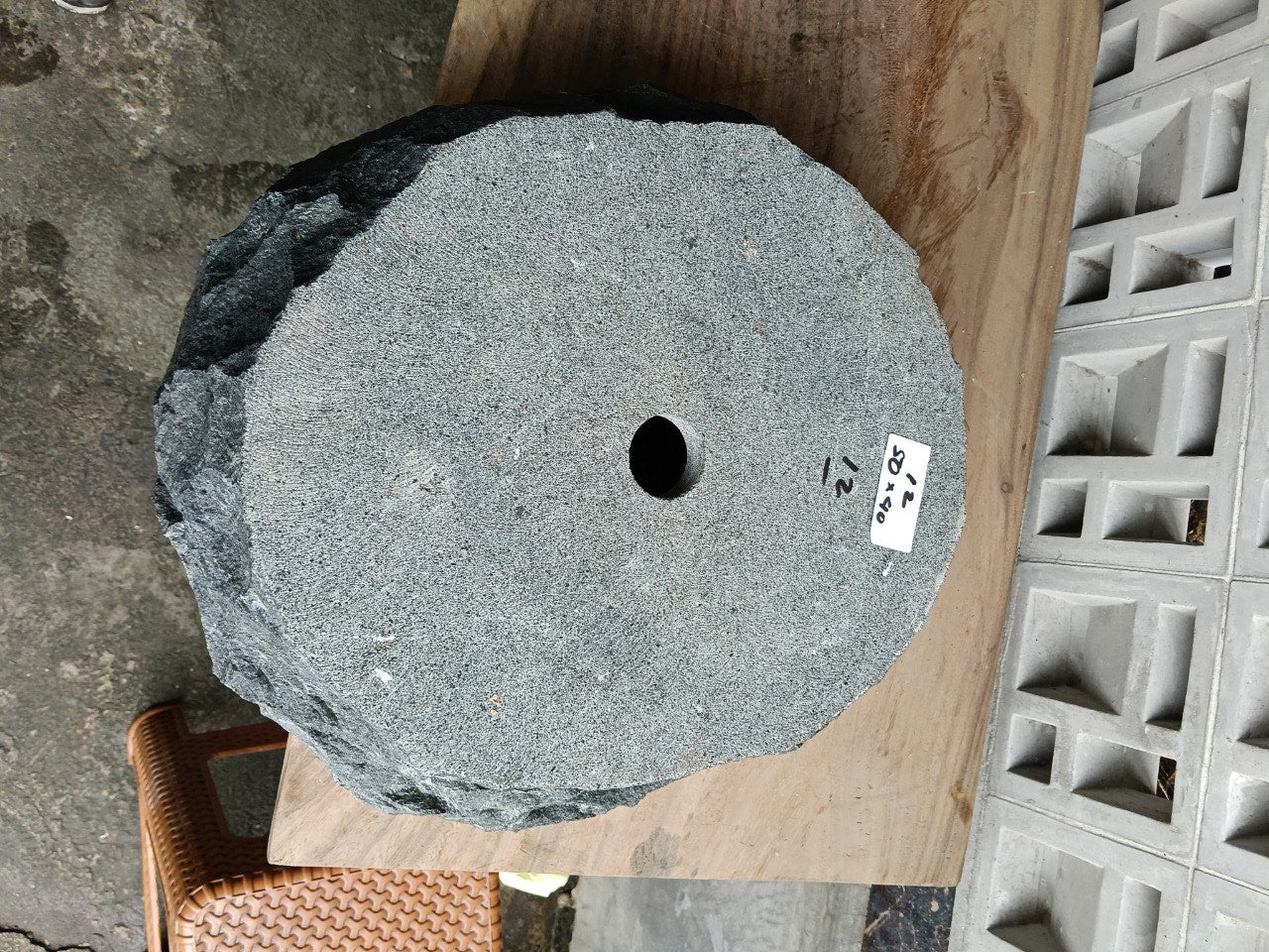 Bottom view of oval andesite stone sink with drain hole
