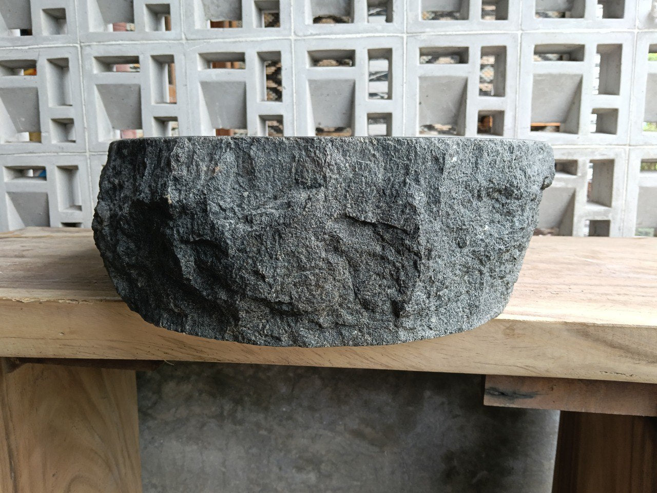 Left side perspective of large oval andesite basin polished interior
