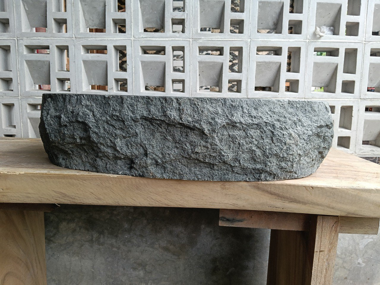Right side view of handcrafted dark gray oval stone sink
